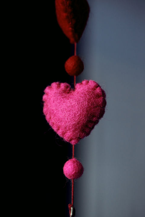 a hand-crafted felt heart hanging from a string